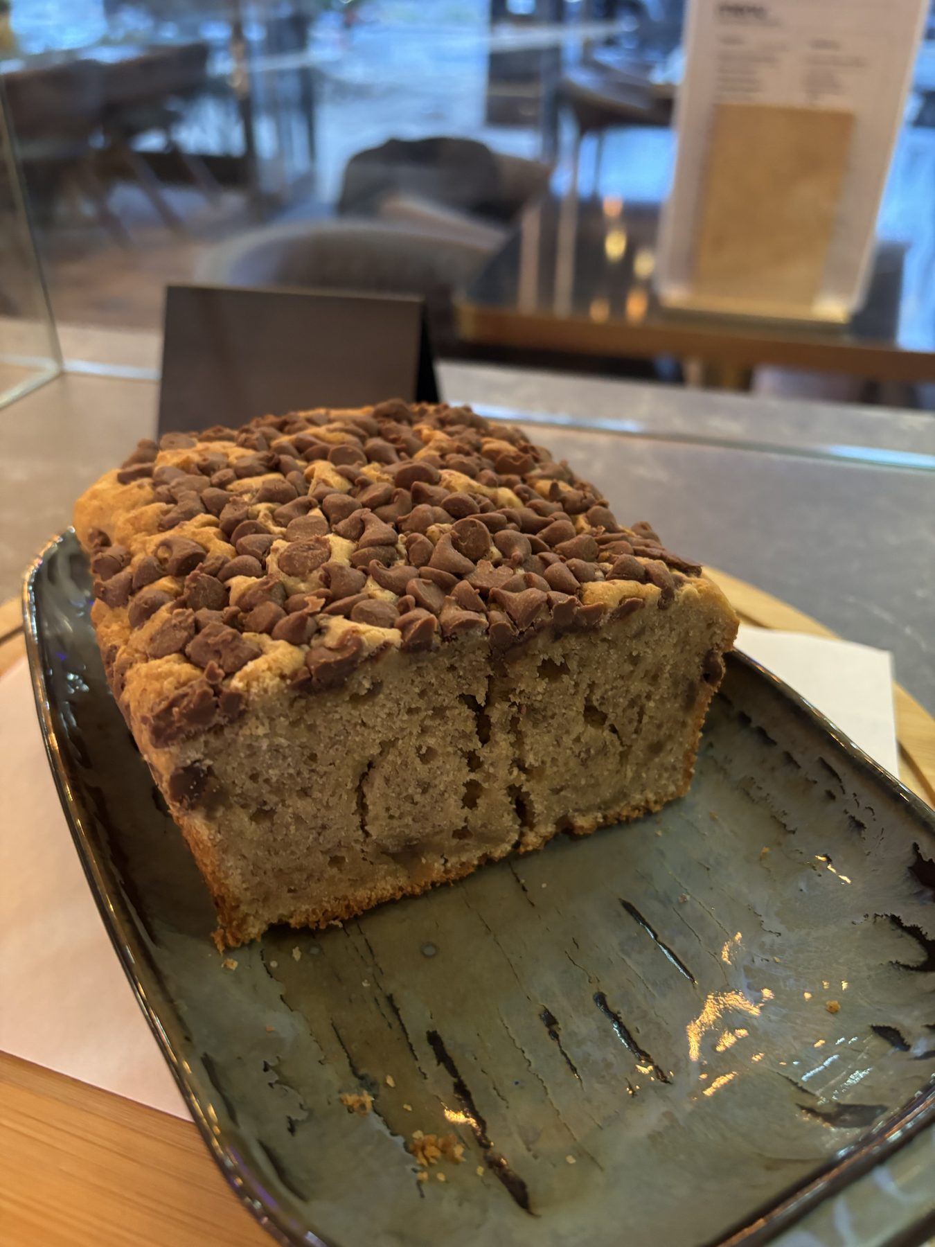A chocolate chip loaf on a ceramic plate.