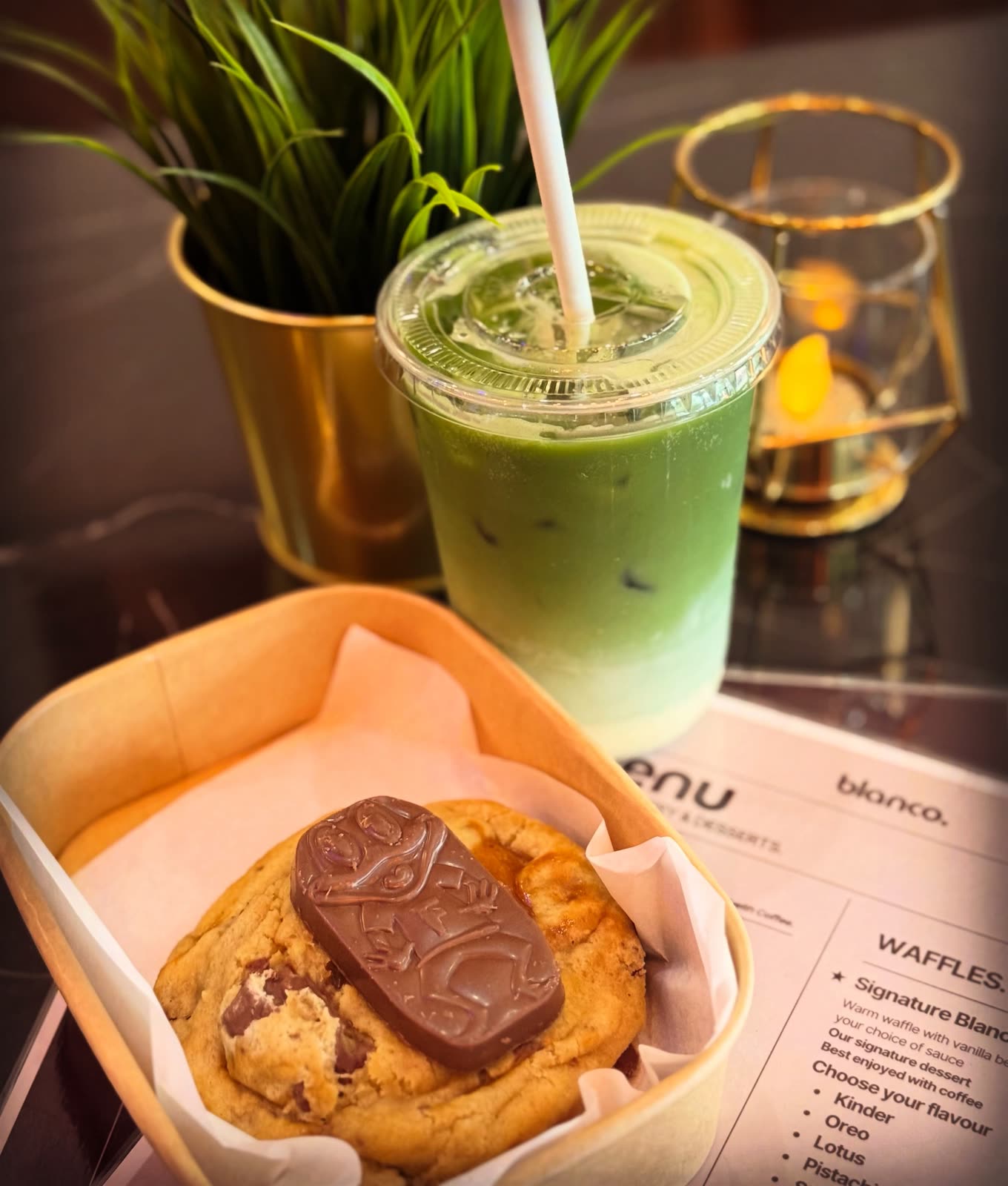 An iced matcha and a chocolate chip cookie at Blanco Coffee House.